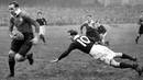 Wales' Wilf Wooller dodges a tackle from Scotland's John Craig