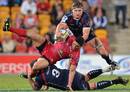 The Rebels' Laurie Weeks tackles the Reds' Anthony Fainga'a