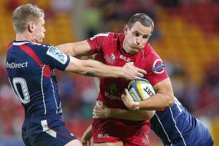The Reds' Mike Harris runs through the tackle of the Rebels' Bryce Hegarty, Queensland Reds v Melbourne Rebels, Super Rugby, Suncorp Stadium, Brisbane, May 17, 2014