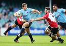 The Waratahs' Bernard Foley takes on the Lions' defence