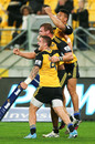 Brad Shields of the Hurricanes celebrates his try with TJ Perenara and Ardie Savea