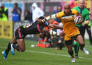 Tom Varndell of Wasps skips the tackle from  Waissea Vuidravuwalu