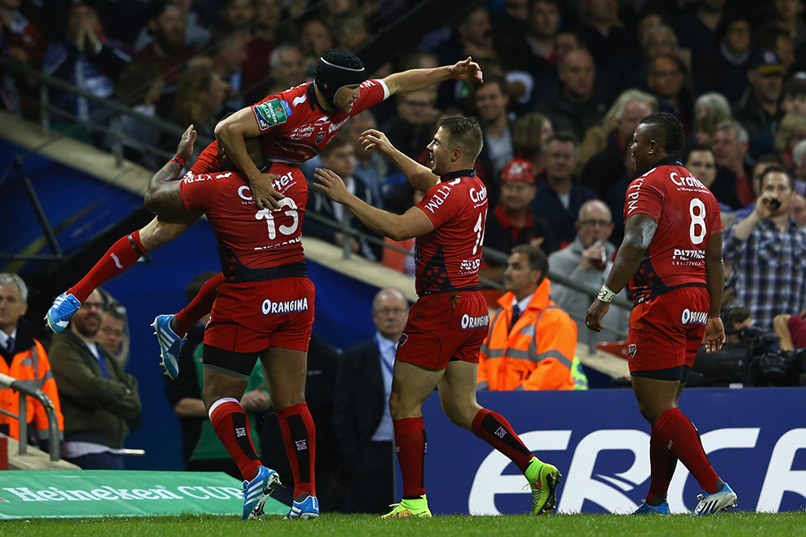 Matt Giteau is congratulated by his Toulon team-mates after scoring the opening try in the Heineken Cup final