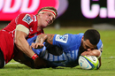 Western Force's Chris Tuatara-Morrison uses hand and nose to ground the ball