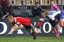 Crusaders winger Johnny McNicholl crosses over for a try