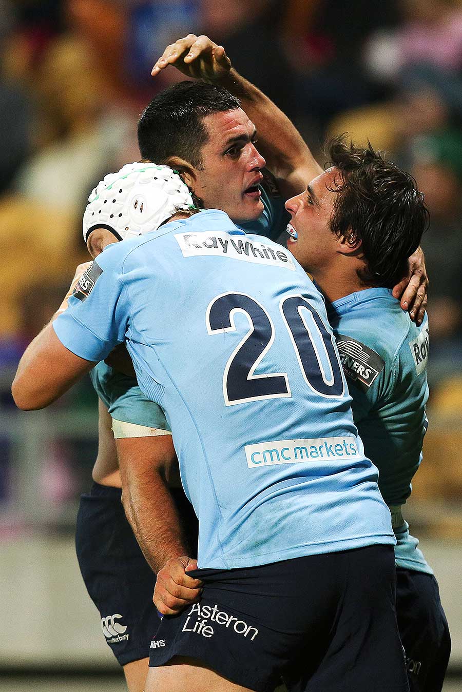 The Waratahs' Stephen Hoiles and Nick Phipps congratulate Dave Dennis
