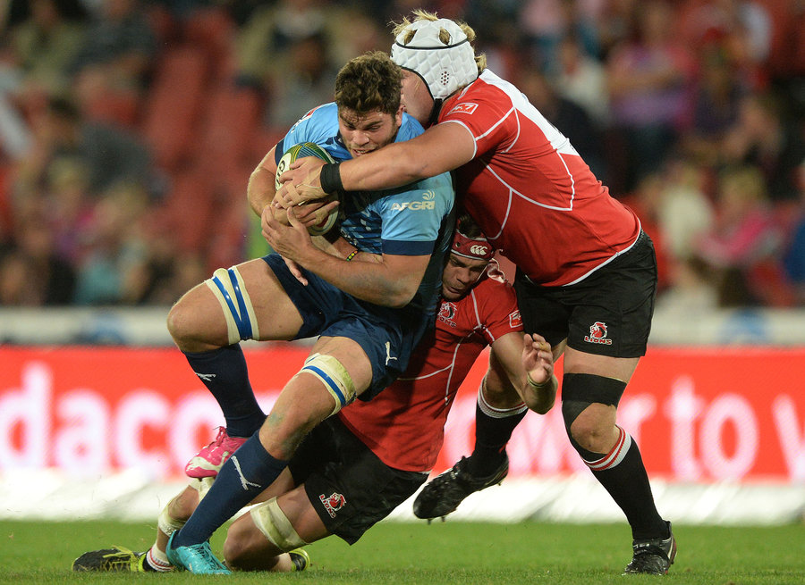 Jono Ross of the Bulls gets tackled