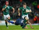 Brian O'Driscoll of Ireland breaks clear of the tackle of Lionel Beauxis of France to score his team's second try
