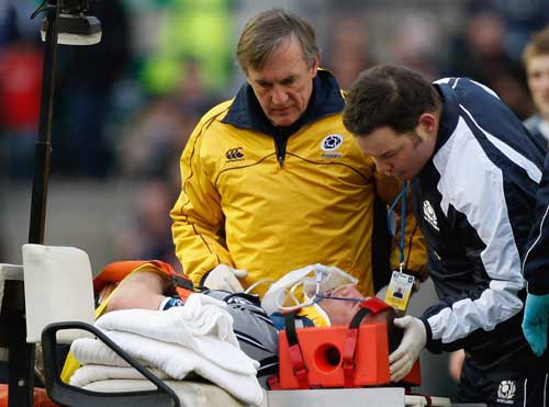 Scotland's Geoff Cross is stretchered from the field against Wales