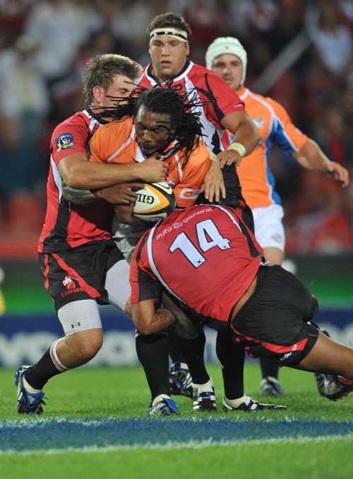 The Cheetahs' Danwel Demas is tackled by the Lions' Ashwin Willemse