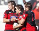 The Crusaders' Tim Bateman is congratulated by team mates Richie McCaw and Jared Payne after scoring a try