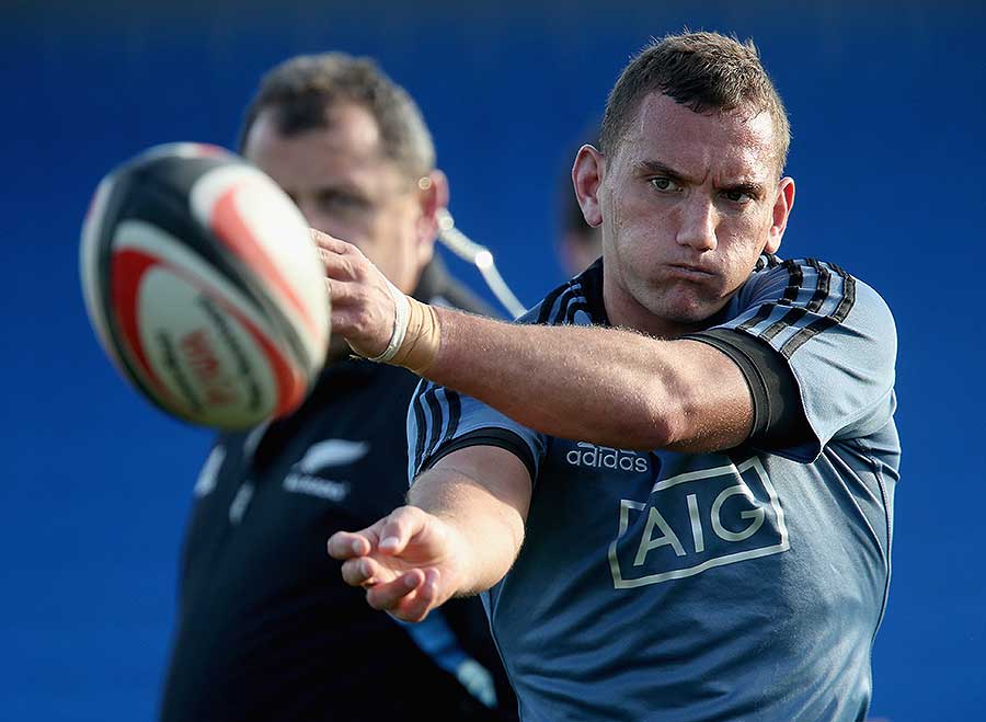 New Zealand's Aaron Cruden passes the ball during a training session