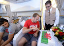 Alun-Wyn Jones cuts a special cake presented on board his flight to South Africa