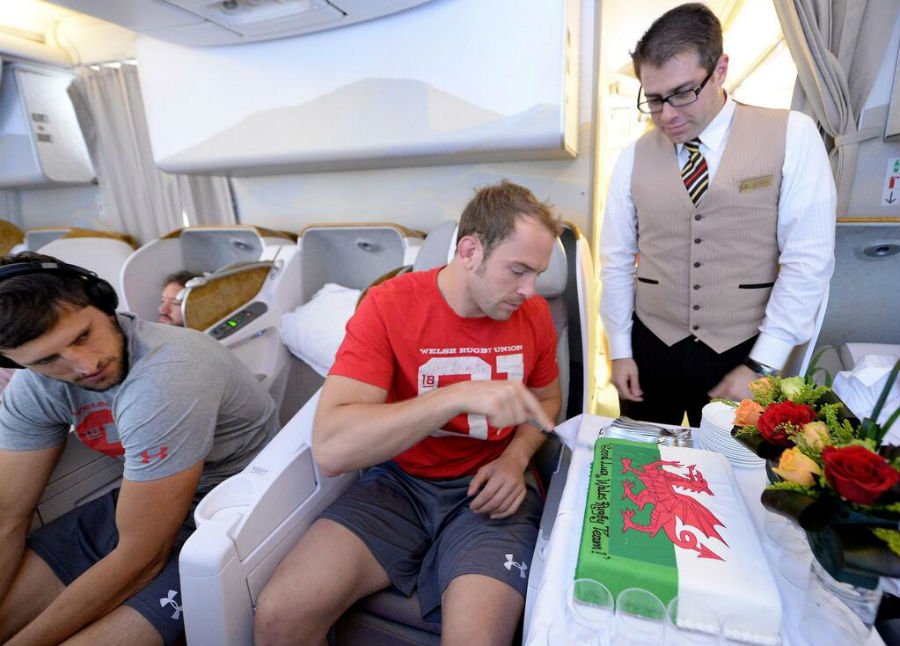 Alun-Wyn Jones cuts a special cake presented on board his flight to South Africa