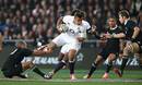 England's Luther Burrell beats the tackle of Aaron Cruden