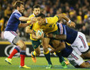 Israel Folau is tackled by the French