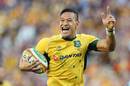 Australia's Israel Folau celebrates as he runs in to score his second try