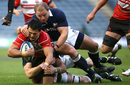 Craig Wing of Japan is tackled by Euan Murray of Scotland