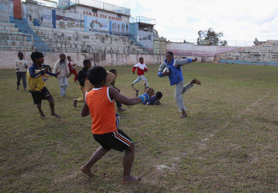 A child runs with the ball during a visit to the Father Pedro Foundation
