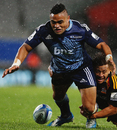 Francis Saili of the Blues loses the ball in slippery conditions
