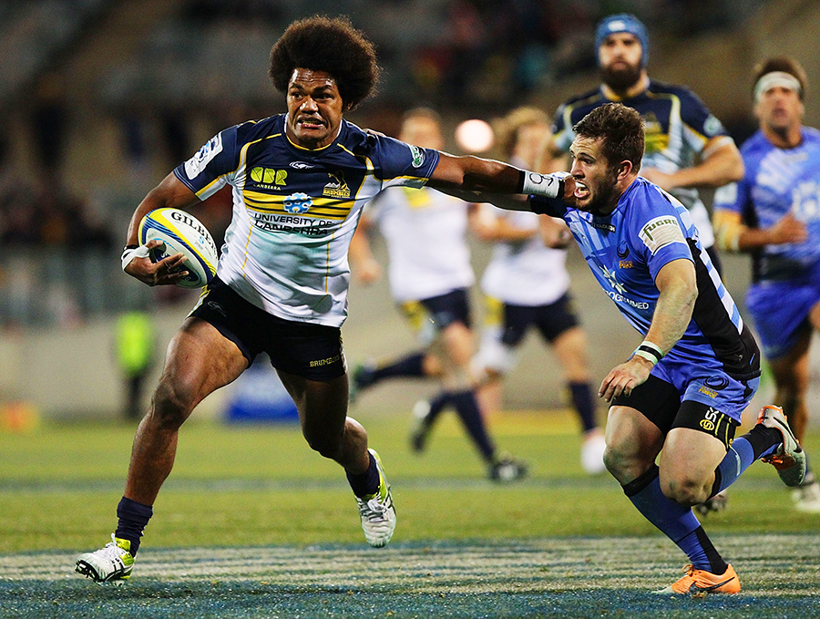 Henry Speight of the Brumbies fends off a tackle