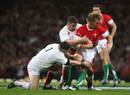 Wales' Andy Powell is tackled by England's Nick Easter and Andrew Sheridan