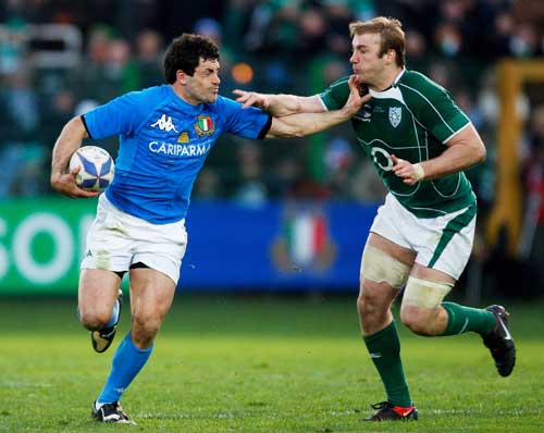 Italy's Andrea Masi fends off Ireland's Stephen Ferris