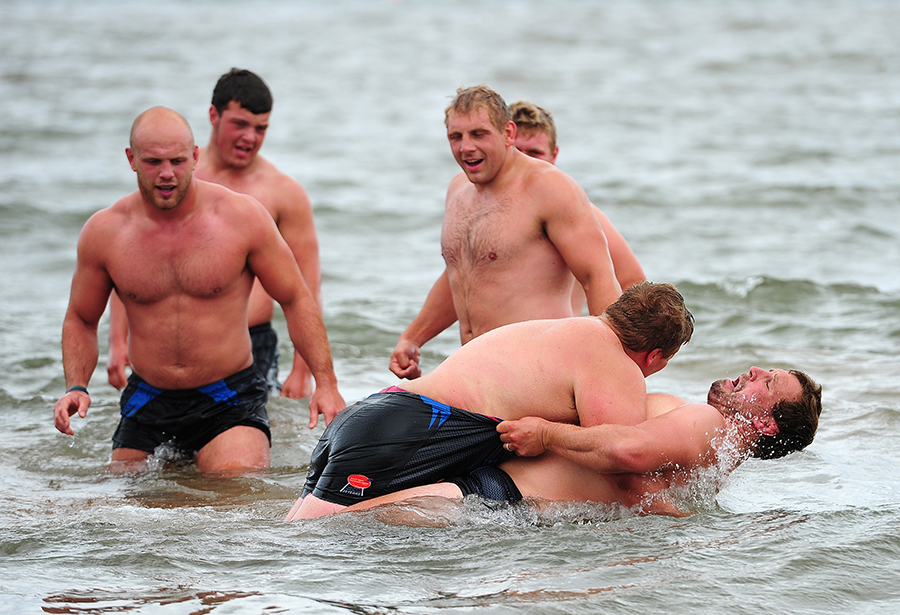 Tomas Francis and Brett Sturgess wrestle in the sea