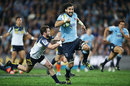 The Waratahs' Jacques Potgieter tears through the Brumbies' defence