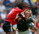 South Africa's Werner Kok is tackled by Trinidad and Tobago's Agboola Silverthorn 