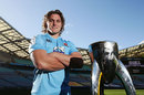 The Waratahs' Michael Hooper poses with the Super Rugby trophy