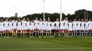 England line up for the anthem against Canada