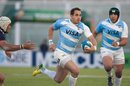 Argentina's fullback Joaquin Tuculet avoids a tackle by Scotland's prop Gordon Reid and he heads for a try