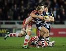 Tommy Taylor is tackled by Elliott Stooke