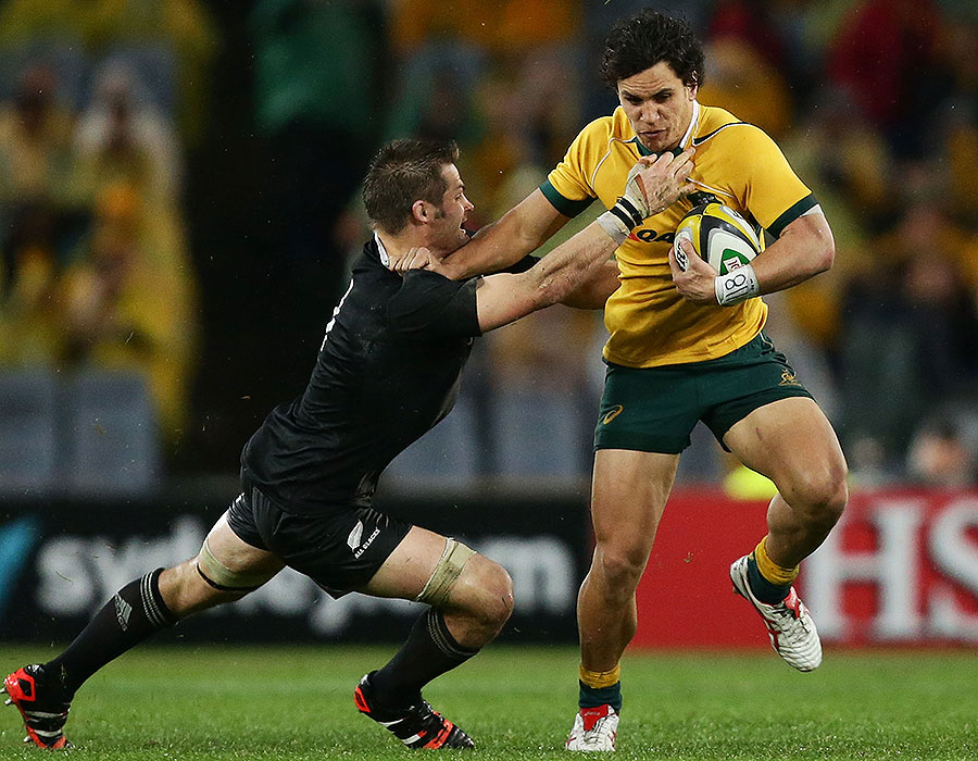 New Zealand's Richie McCaw tackles Australia's Matt Toomua