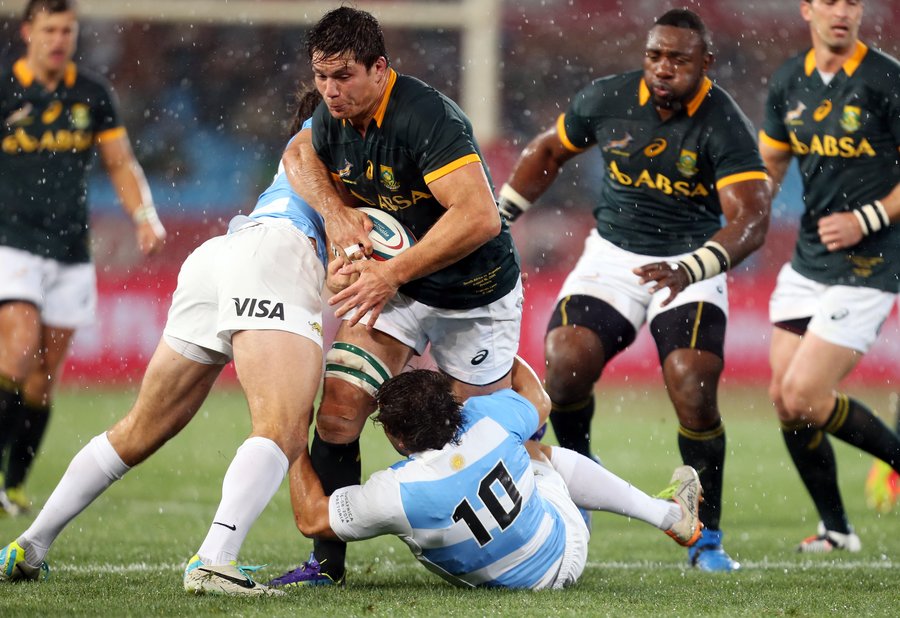 Damian de Allende of South Africa is tackled