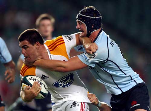 The Chiefs' Dwayne Sweeney is tackled by the Waratahs' Dean Mumm