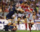The Crusaders' Jared Payne is tackled by the Brumbies' defence