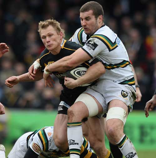 Josh Lewsey looks to break the tackle of Mark Easter