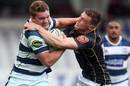 Blake Gibson (L) of Auckland attempts to push off Jason Woodward