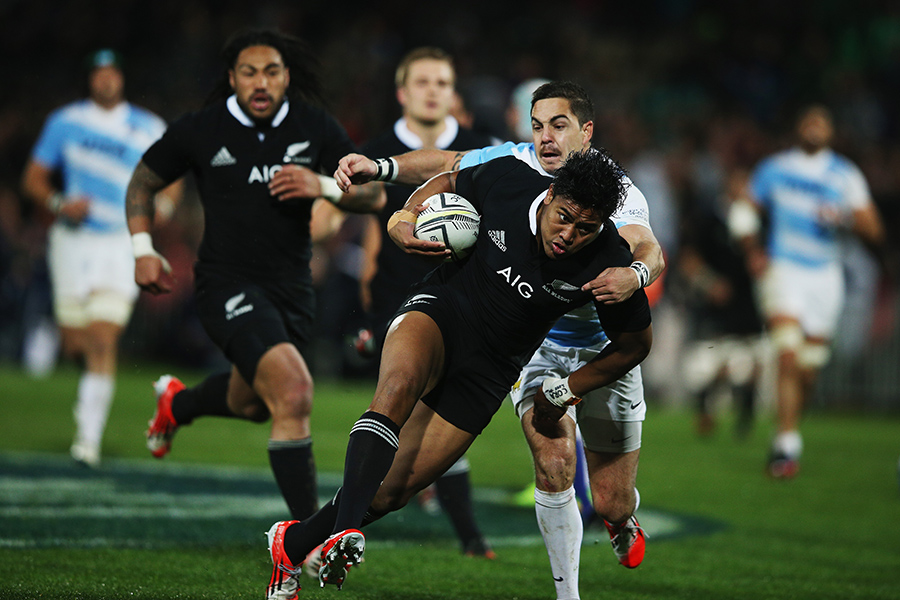 All Blacks' wing Julian Savea breaks through an Argentina tackle to crash over for his second try