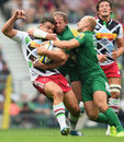 Harlequins' Nick Easter is caught by the London Irish defence