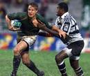 South Africa's Jean de Villiers breaks past the Fijian tackler