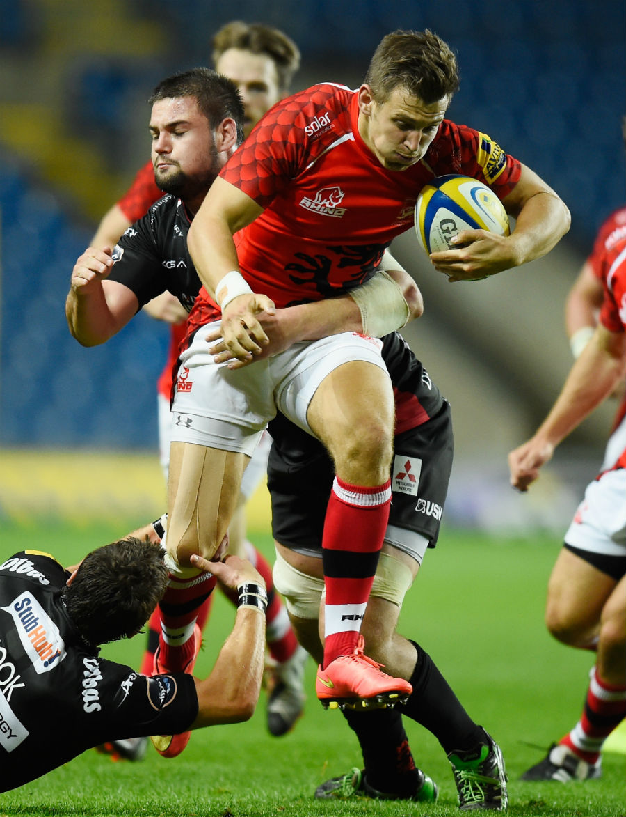 Nick Scott of London Welsh is tackled by James Hook and Elliot Stooke