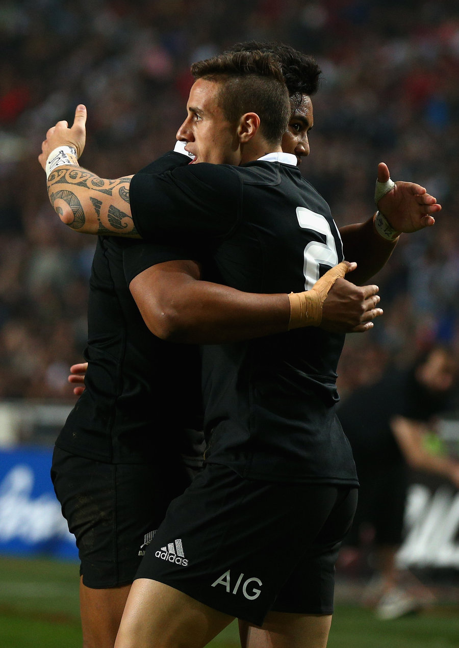 TJ Perenara of the All Blacks celebrates scoring a try with team mate Julian Savea