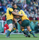 Handre Pollard of South Africa is tackled by James Horwill and Saia Fainga'a