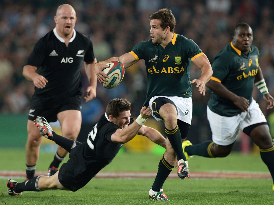 Cobus Reich of South Africa breaks through the All Blacks defence