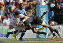Charlie Hayter of England is hammered by the Fiji defence