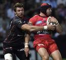 Toulouse's Vincent Clerc gets hold of Leigh Halfpenny
