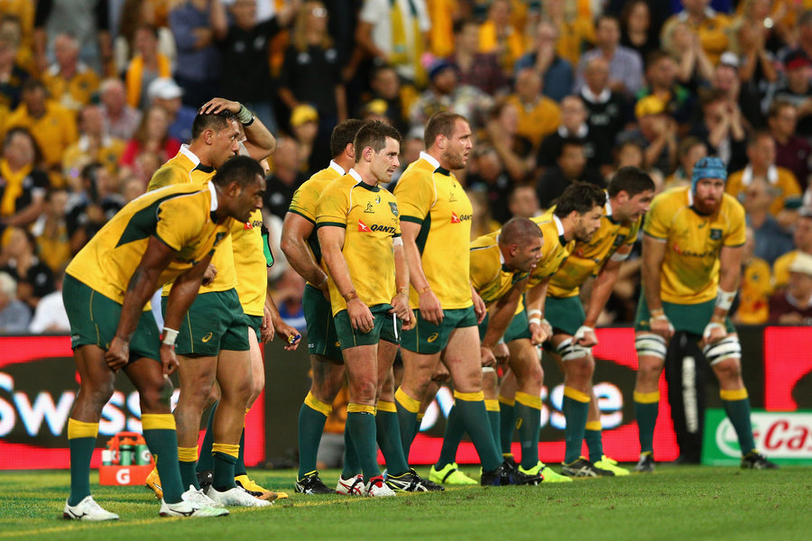 The Wallabies look on as Colin Slade takes his winning conversion